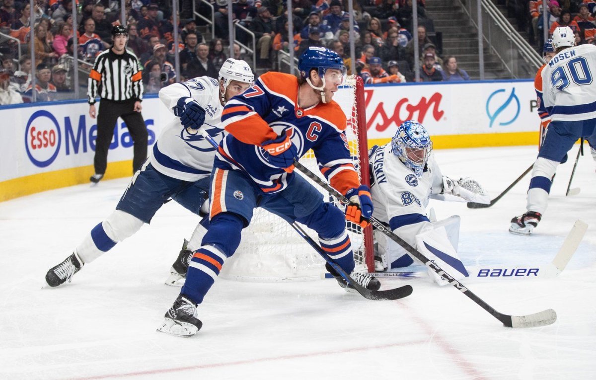 Tampa Bay Lightning goalie Andrei Vasilevskiy (88) makes a save on Edmonton Oilers' Connor McDavid (97) as Ryan McDonagh (27) defends during second period NHL action in Edmonton on Tuesday, Dec. 10, 2024. THE CANADIAN PRESS/Jason Franson.