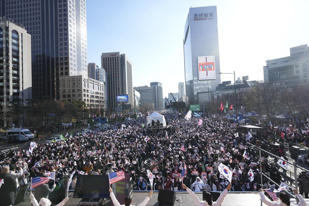 People gather during a rally held by conservative groups supporting South Korean President Yoon Suk Yeol and denouncing opposition parties’ lawmakers who demanding impeachment of the president, in Seoul, South Korea, Saturday, Dec. 7, 2024, following the president’s short-lived martial law declaration. (AP Photo/Lee Jin-man)