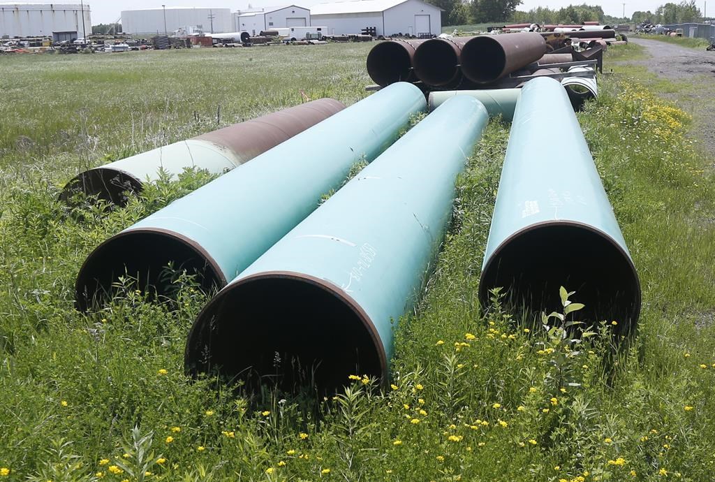 FILE - Pipeline used to carry crude oil sits at the Superior, Wis., terminal of Enbridge Energy, June 29, 2018. (AP Photo/Jim Mone, File).