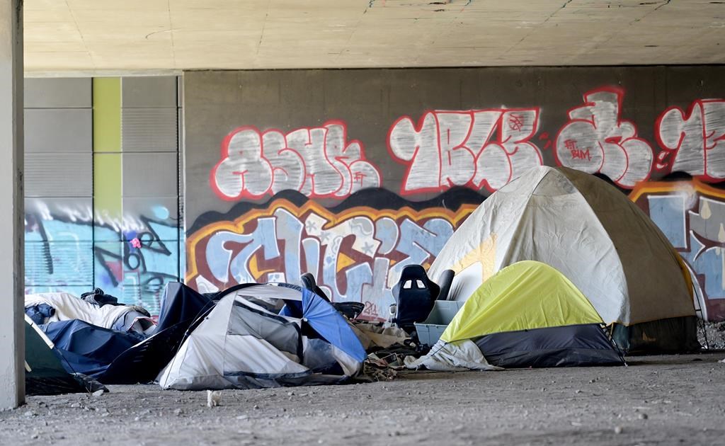 The federal and provincial governments have announced a $100-million agreement to help fight homelessness in Quebec. A homeless camp is shown beneath an overpass in Montreal, Friday, April 14, 2023. THE CANADIAN PRESS/Graham Hughes.