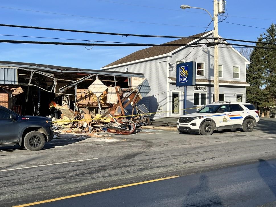 The RCMP say that four people in eastern Newfoundland are facing charges after someone used a stolen backhoe to tear off the front of the RBC bank in Holyrood. A view of the bank building is seen in an undated police handout photo. THE CANADIAN PRESS/HO-RCMP, *MANDATORY CREDIT*.