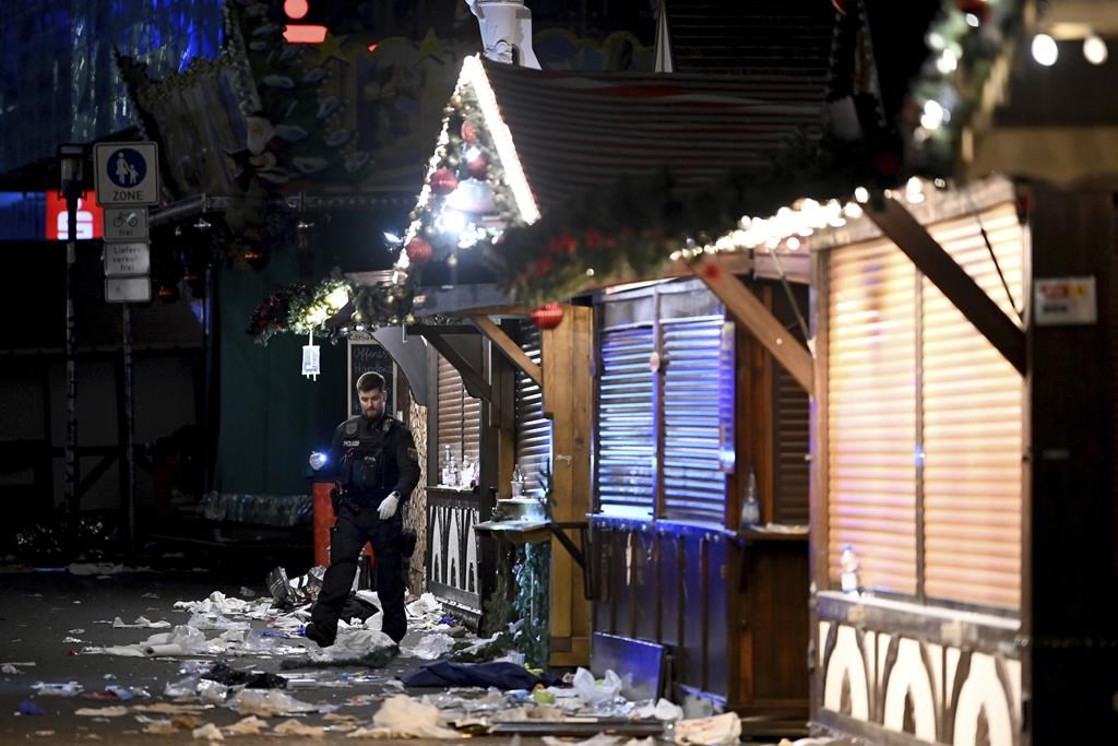 A policeman is seen at the Christmas market where an incident happened in Magdeburg, Germany, Friday Dec. 20, 2024.
