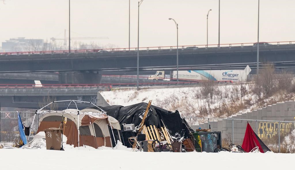 A homeless encampment of tents are seen near the highway in the west end of Montreal