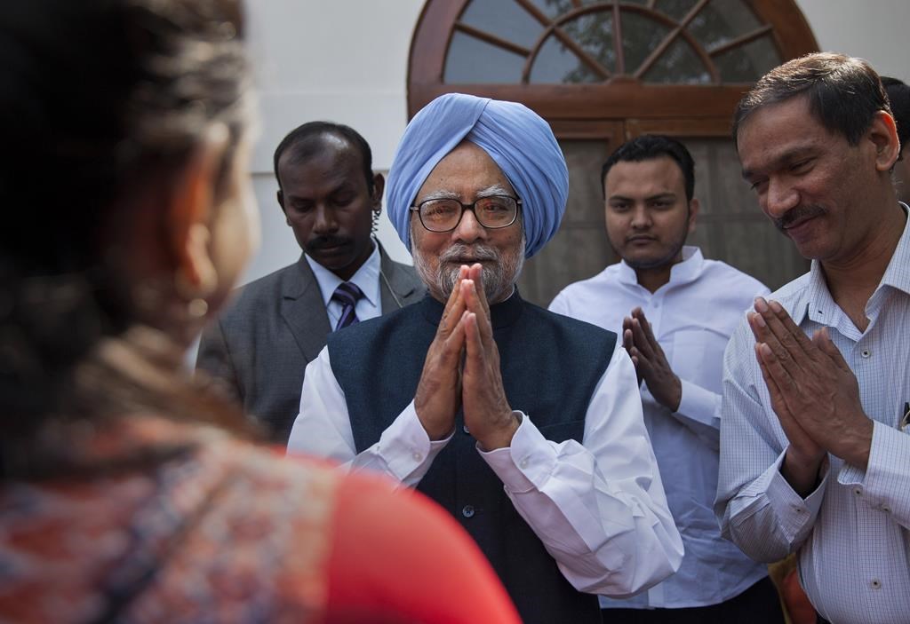 FILE - Former Indian prime minister Manmohan Singh, centre, gestures after a short meeting with the newly elected office bearers of "National Students' Union Of India" (NSUI), who called on him at his residence in New Delhi, India, Tuesday, March 17, 2015.