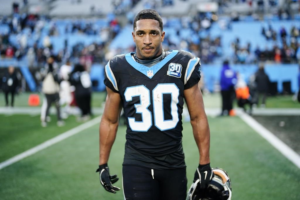 Carolina Panthers running back Chuba Hubbard leaves the field after scoring the winning touchdown against the Arizona Cardinals during overtime of an NFL football game, Sunday, Dec. 22, 2024, in Charlotte, N.C.