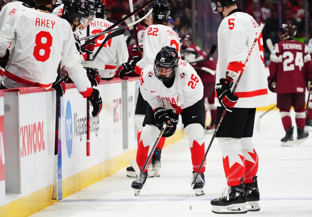 Canada's Matthew Schaefer (25) leaves the ice after colliding with the net during first period IIHF World Junior Hockey Championship preliminary round action against Latvia in Ottawa on Friday, Dec. 27, 2024.