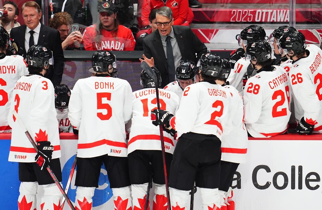 Canada head coach Dave Cameron speaks to his players during third period IIHF World Junior Hockey Championship preliminary round action against Latvia in Ottawa on Friday, Dec. 27, 2024.