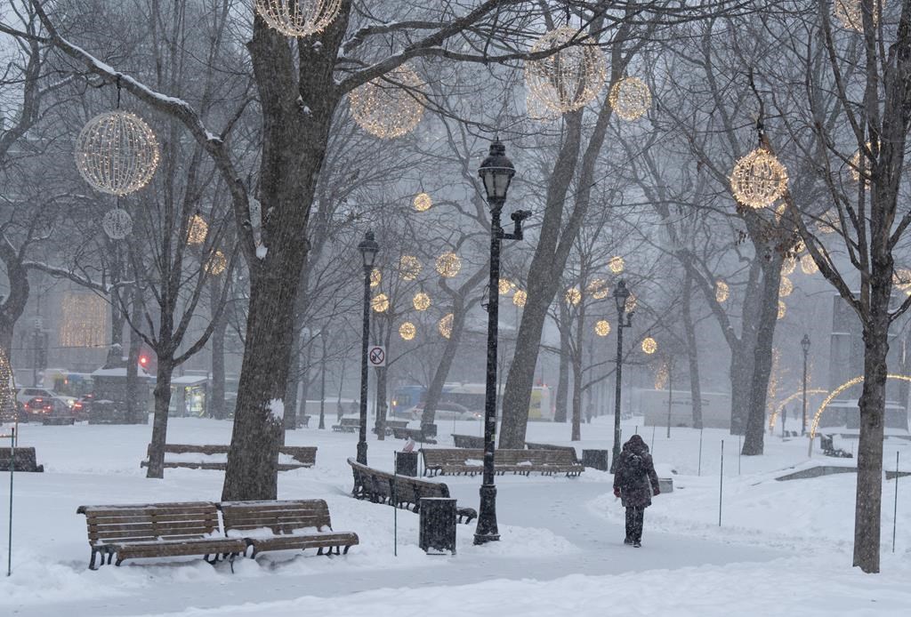 A freezing rain warning is in effect for several regions of Quebec today, with possible icy conditions for drivers. People walk in downtown Montreal, Tuesday, Jan. 9, 2024.