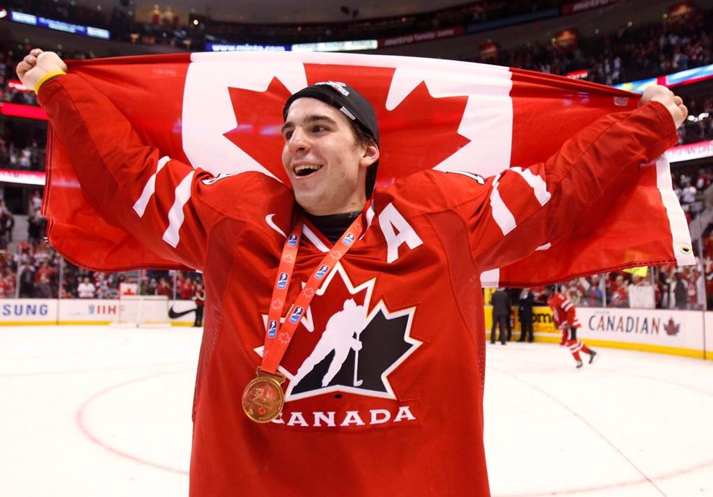 FILE - Canada's John Tavares holds up a Canadian flag after beating Sweden in the final at the world junior hockey championship in Ottawa on Monday, Jan. 5, 2009. 