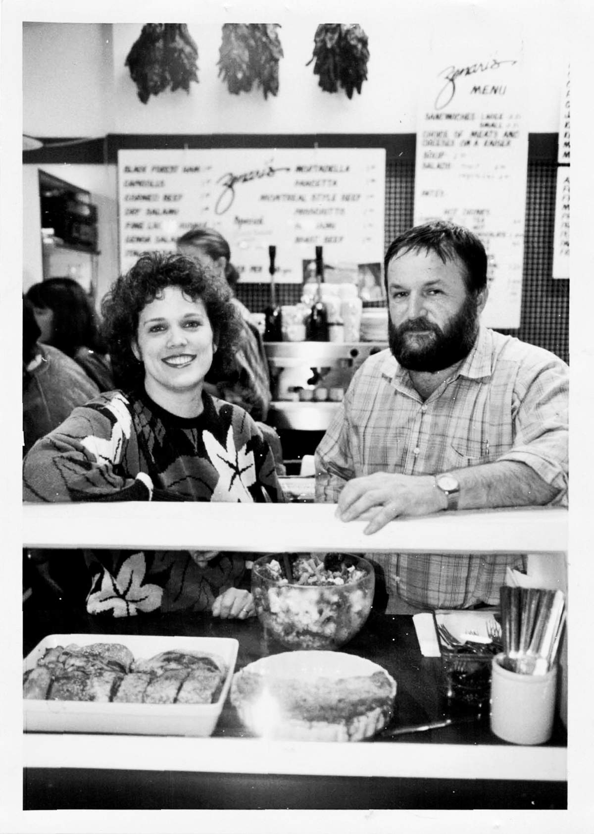 Glenda and Adriano Zenari sitting at the counter of their Deli