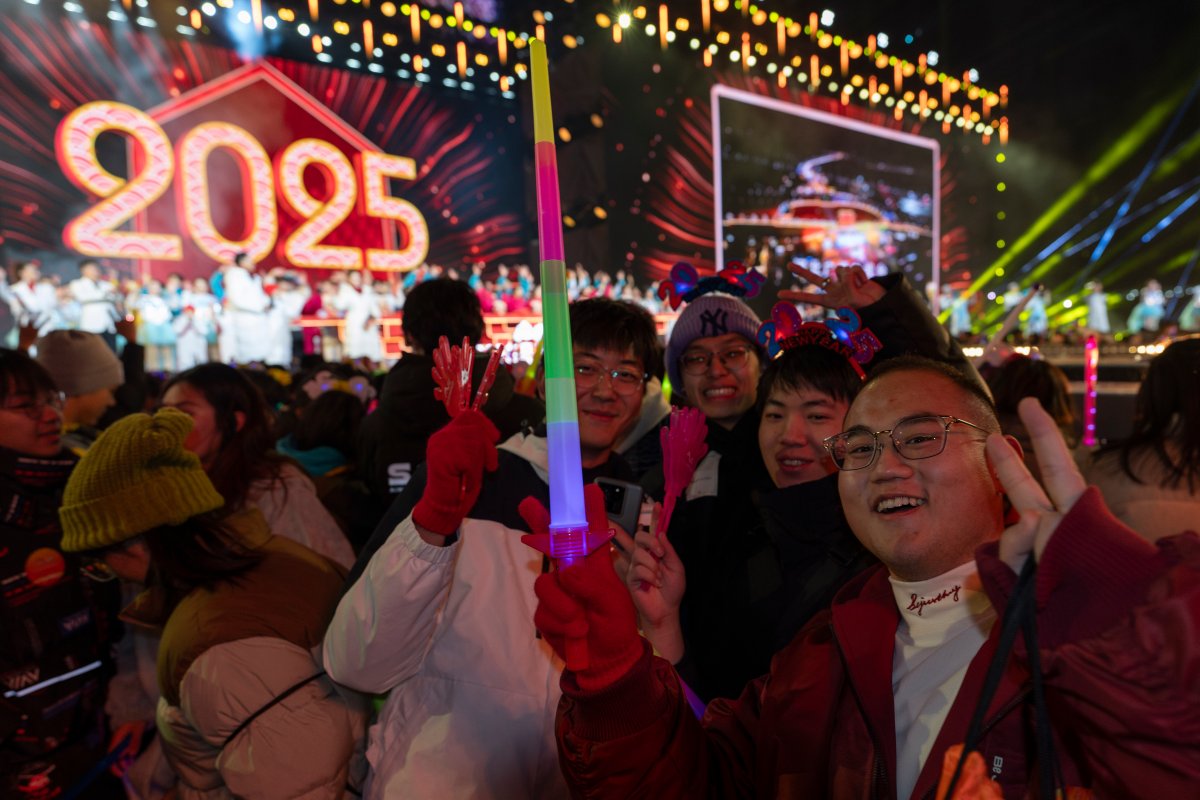 Revelers ring in the new year during a count down event held in Beijing, Wednesday, Jan. 1, 2025. (AP Photo/Ng Han Guan)