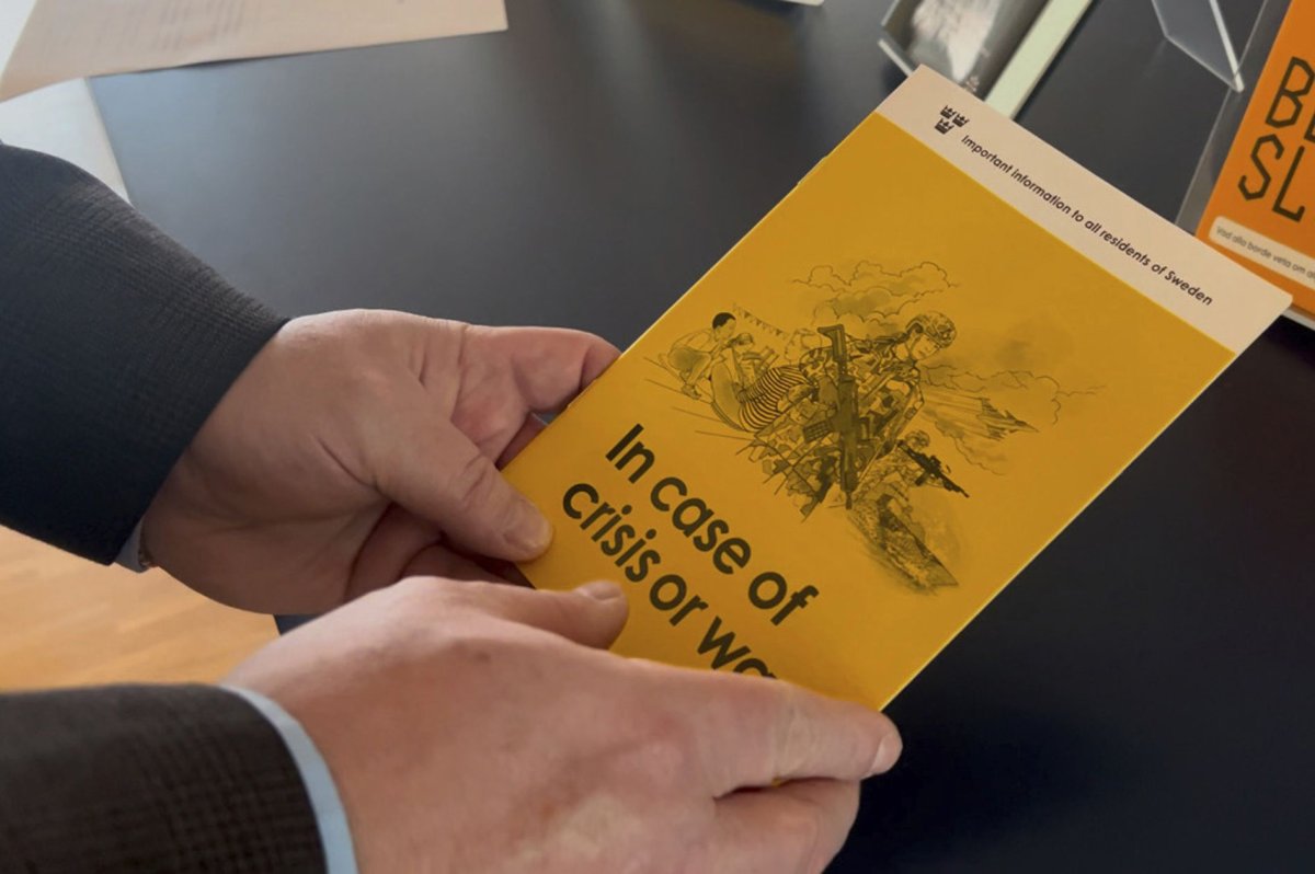 Jan-Olof Olsson, Critical Infrastructure Protection (CIP) expert at the Swedish Civil Contingencies Agency (MSB) holds a yellow crisis preparedness brochure titled "In case of crisis or war", which was distributed to all Swedish households, Thursday, Dec. 26, 2024, in Karlstad, Sweden.