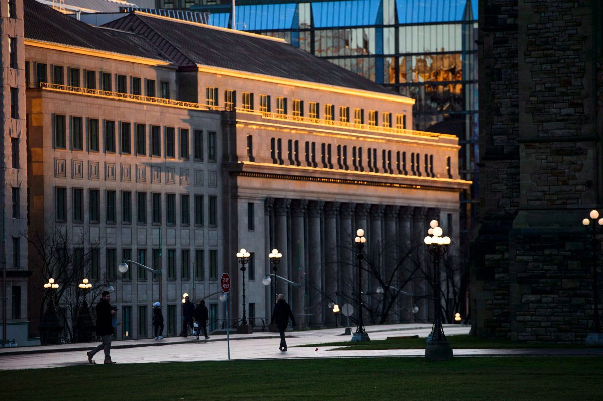 FILE - Evening light hits the Wellington building as people make their way on Parliament Hill in Ottawa on Tuesday, Nov. 6, 2018.THE CANADIAN PRESS/Sean Kilpatrick.