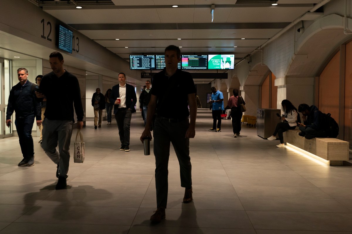 Commuters walk through Union Station as a national rail shutdown causes delays, after employees were locked out by both major Canadian railways after a deadlock in contract negotiations, in Toronto, Thursday, Aug. 22, 2024. 