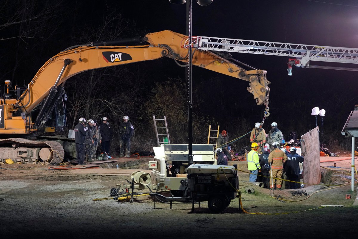 Rescue workers search through the night in a sinkhole for Elizabeth Pollard, who disappeared while looking for her cat, in Marguerite, Pa., Tuesday, Dec. 3, 2024.