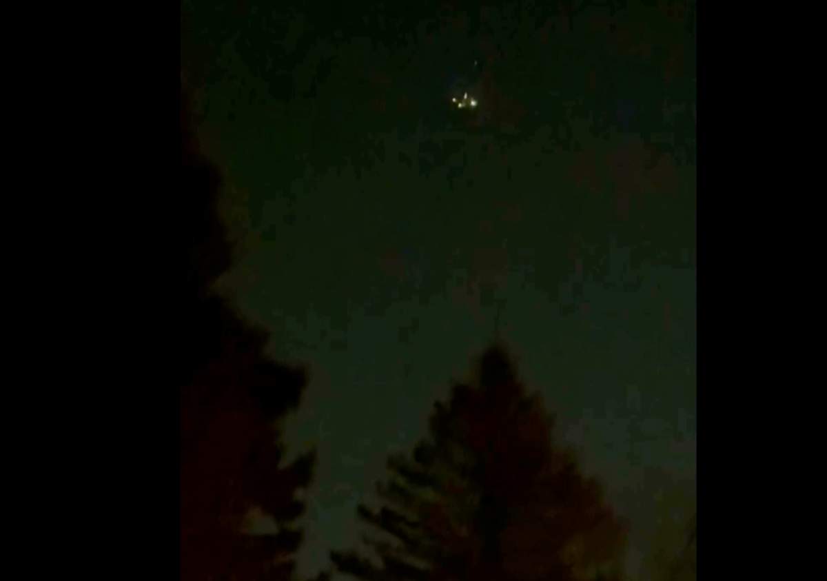 In this image taken from video, what appears to be a drone is seen above treetops in Flanders, N.J., Dec. 3, 2024.