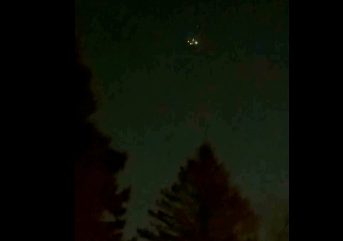 In this image taken from video, what appears to be a drone is seen above treetops in Flanders, N.J., Dec. 3, 2024.