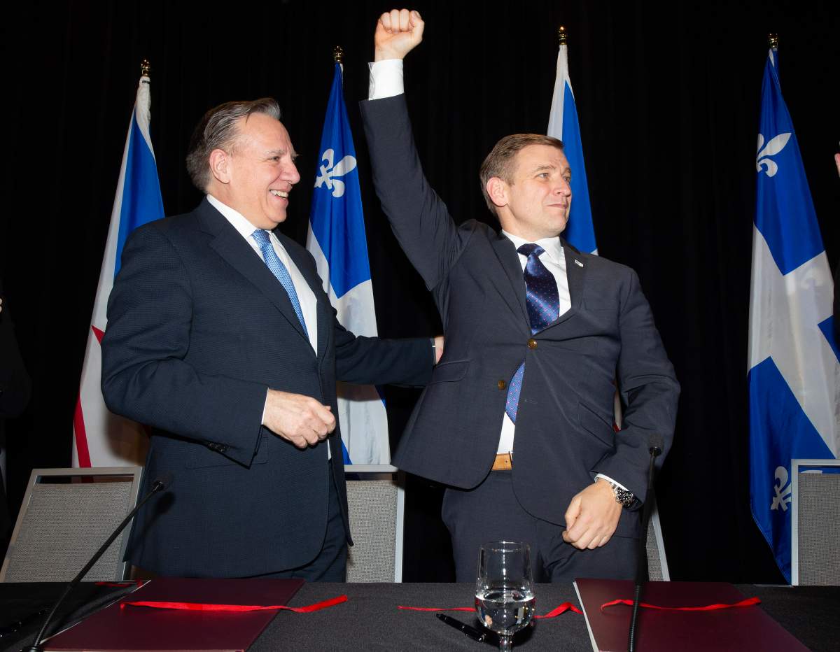Quebec Premier Francois Legault and Andrew Furey, Premier of Newfoundland and Labrador react after signing a memorandum of understanding during an announcement in St.John’s, Thursday, Dec. 12, 2024.