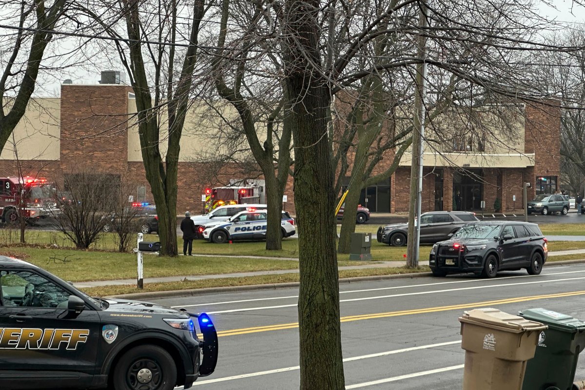 Emergency vehicles are parked outside the Abundant Life Christian School in Madison, Wis., where multiple injuries were reported following a shooting, Monday, Dec. 16, 2024.