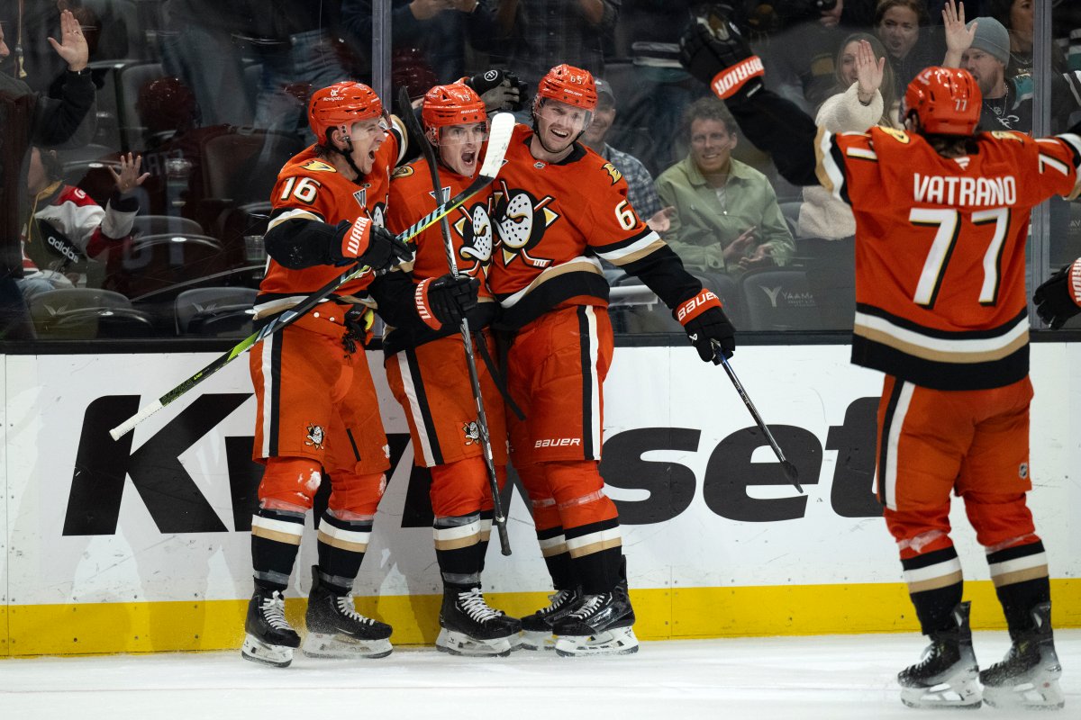 Anaheim Ducks right wing Troy Terry (19) celebrates his goal with center Ryan Strome (16), defenseman Jacob Trouba (65), and right wing Frank Vatrano (77) during the third period of an NHL hockey game against the Winnipeg Jets, Wednesday, Dec. 18, 2024, in Anaheim, Calif. (AP Photo/Kyusung Gong).