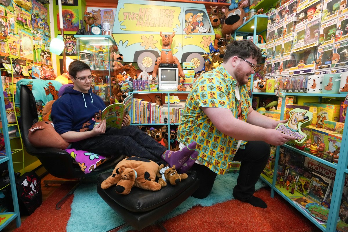 Tristan Sacrey, right, and Brad Flowers are seen with part of the Scooby Doo merchandise collection that is displayed in a room of their Brampton, Ontario home on Sunday November 24, 2024. THE CANADIAN PRESS/Chris Young