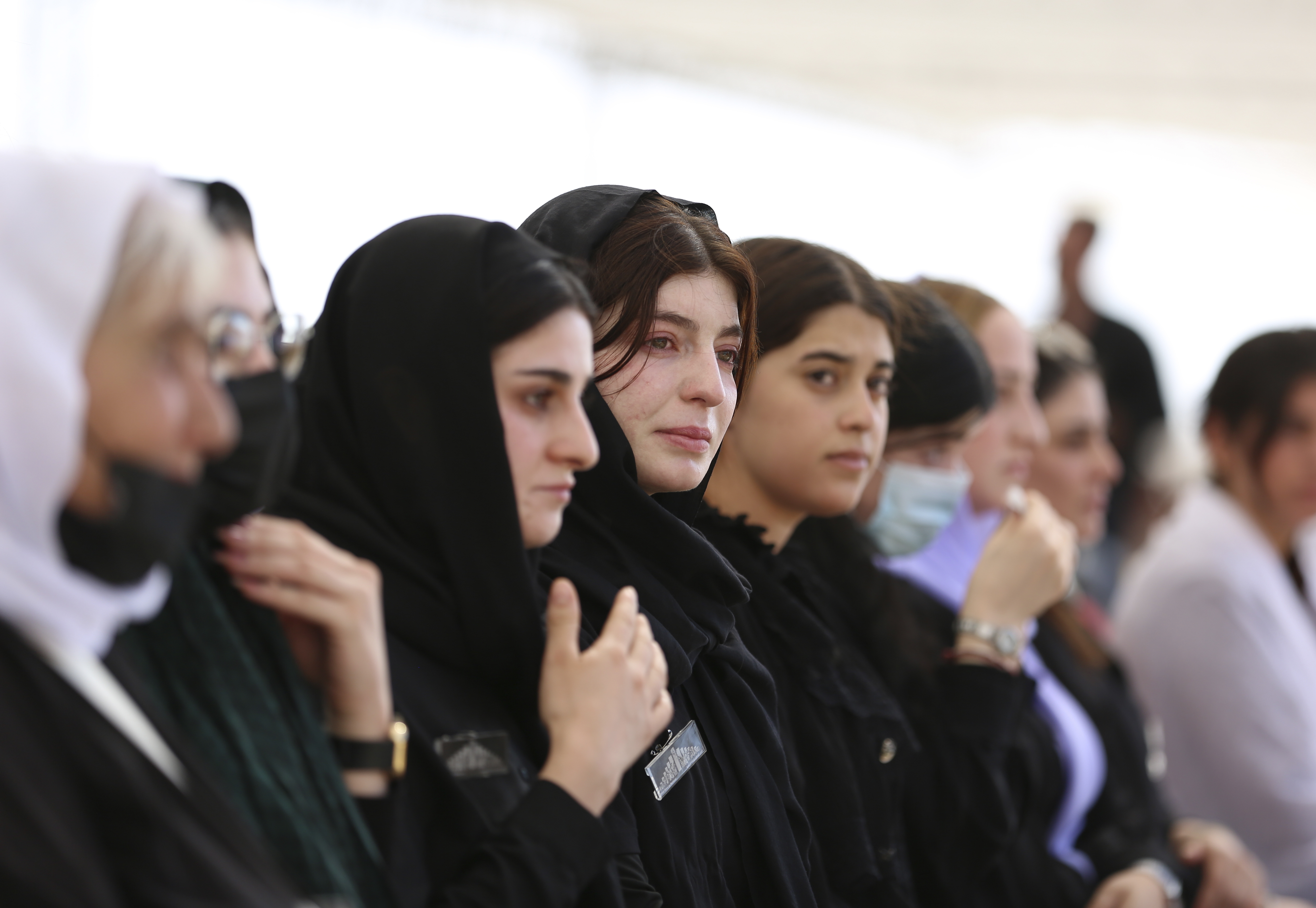 Iraqi Yazidi women mourn relatives at commemoration of the 10th anniversary of Yazidi genocide in Sinjar, Iraq, Aug. 3, 2024. (AP Photo/Farid Abdulwahed)