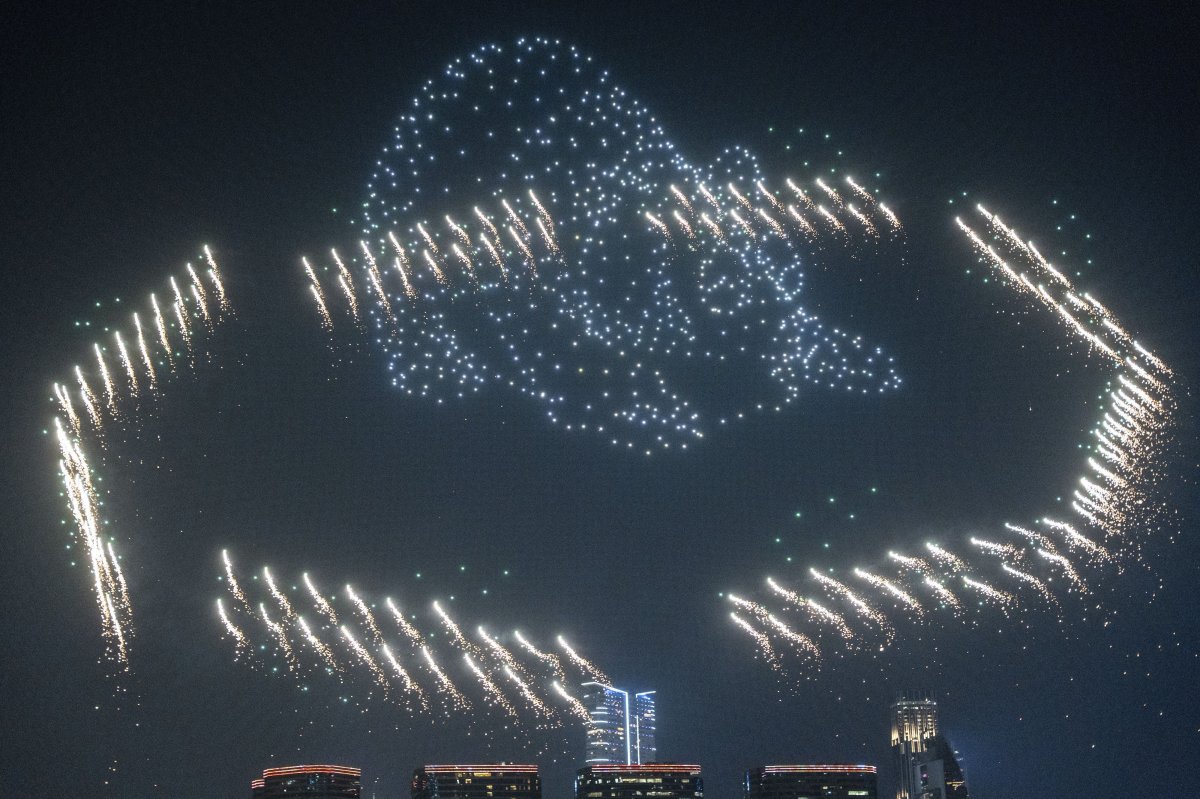 People watch the panda-themed drone show at the waterfront of the Victoria Harbour in Hong Kong, Saturday, Dec. 28, 2024.