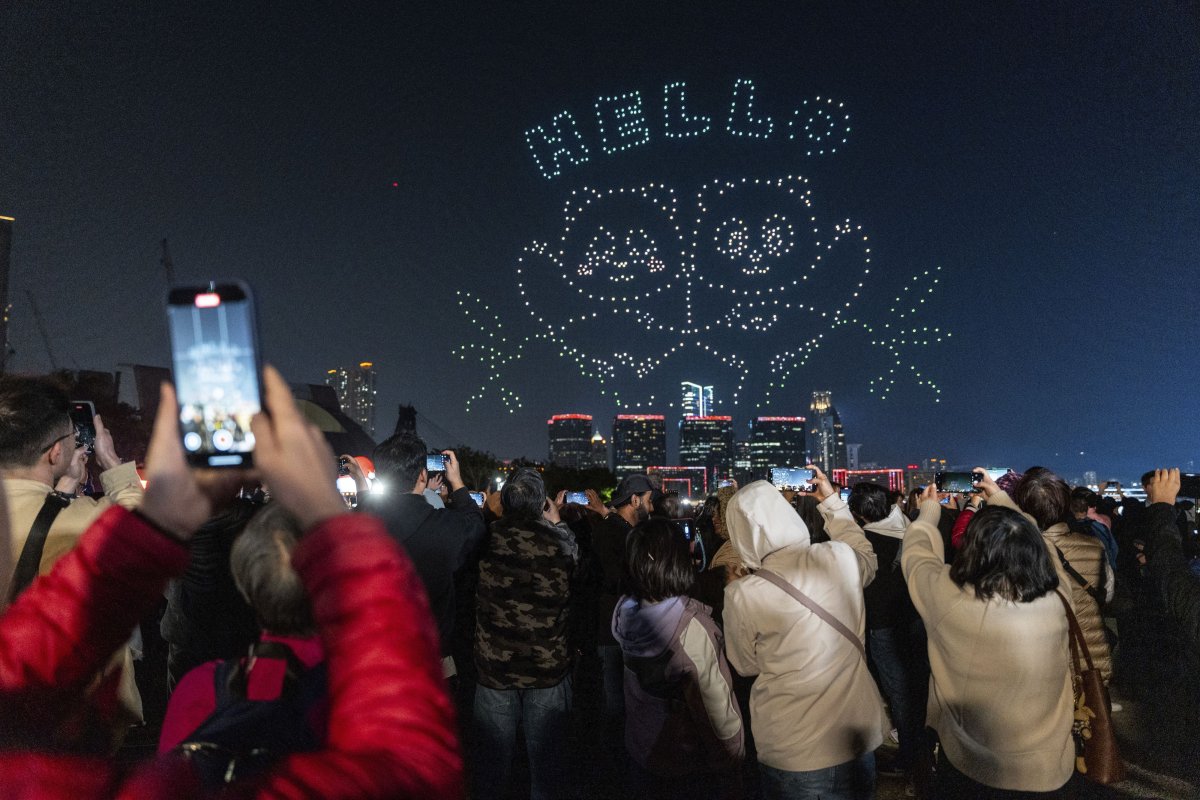 People watch the panda-themed drone show at the waterfront of the Victoria Harbour in Hong Kong, Saturday, Dec. 28, 2024.