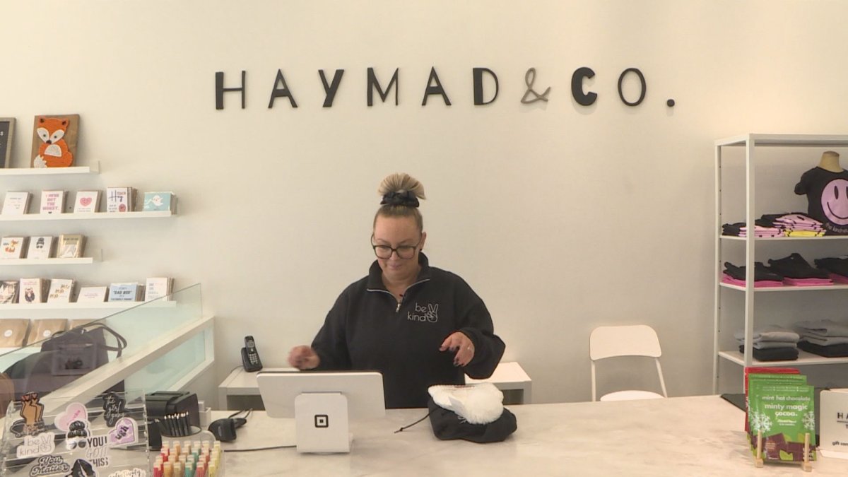 Amber Nemeth, owner of HayMad & Co. rings some Be Kind merch through to cash register.