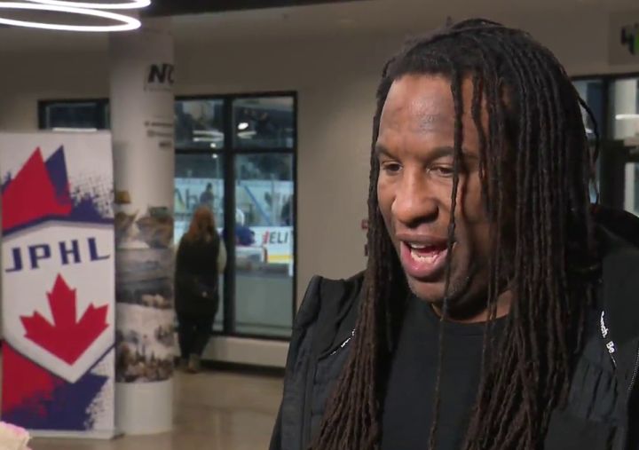 Former NHL player George Laraque is interviewed in Edmonton in 2024.