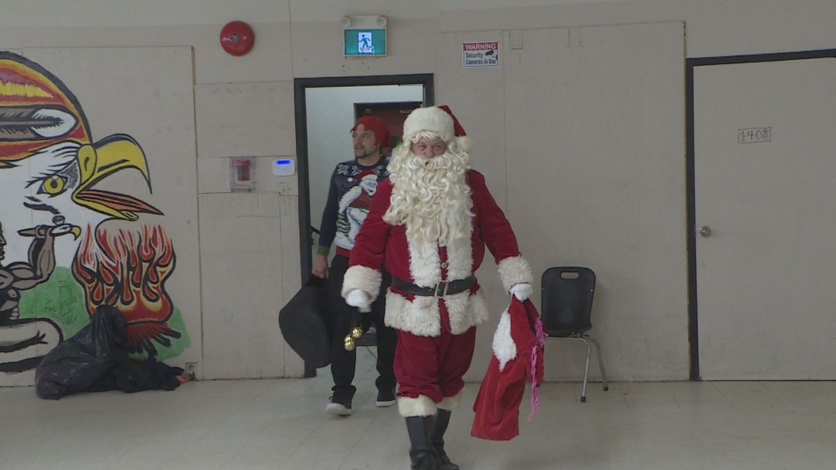 Santa visits those eating a Christmas lunch at N’Dinawemak on Dec. 20, 2024.