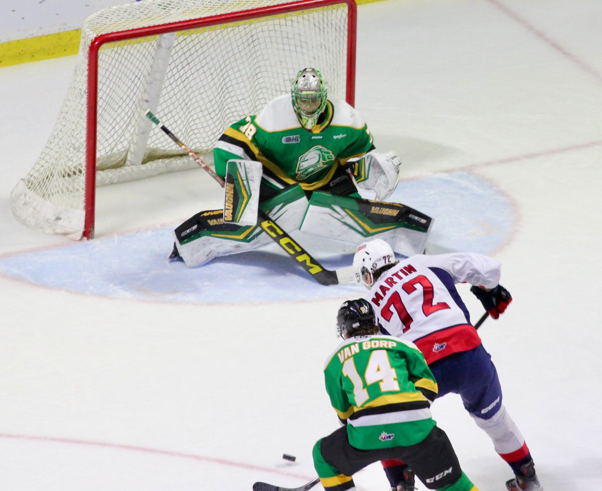 Alexei Medvedev of the London Knights makes one of his 39 saves as he stops Ethan Martin of the Windsor Spitfires in a game played at the WFCU Centre on Saturday, Dec. 14, 2024.