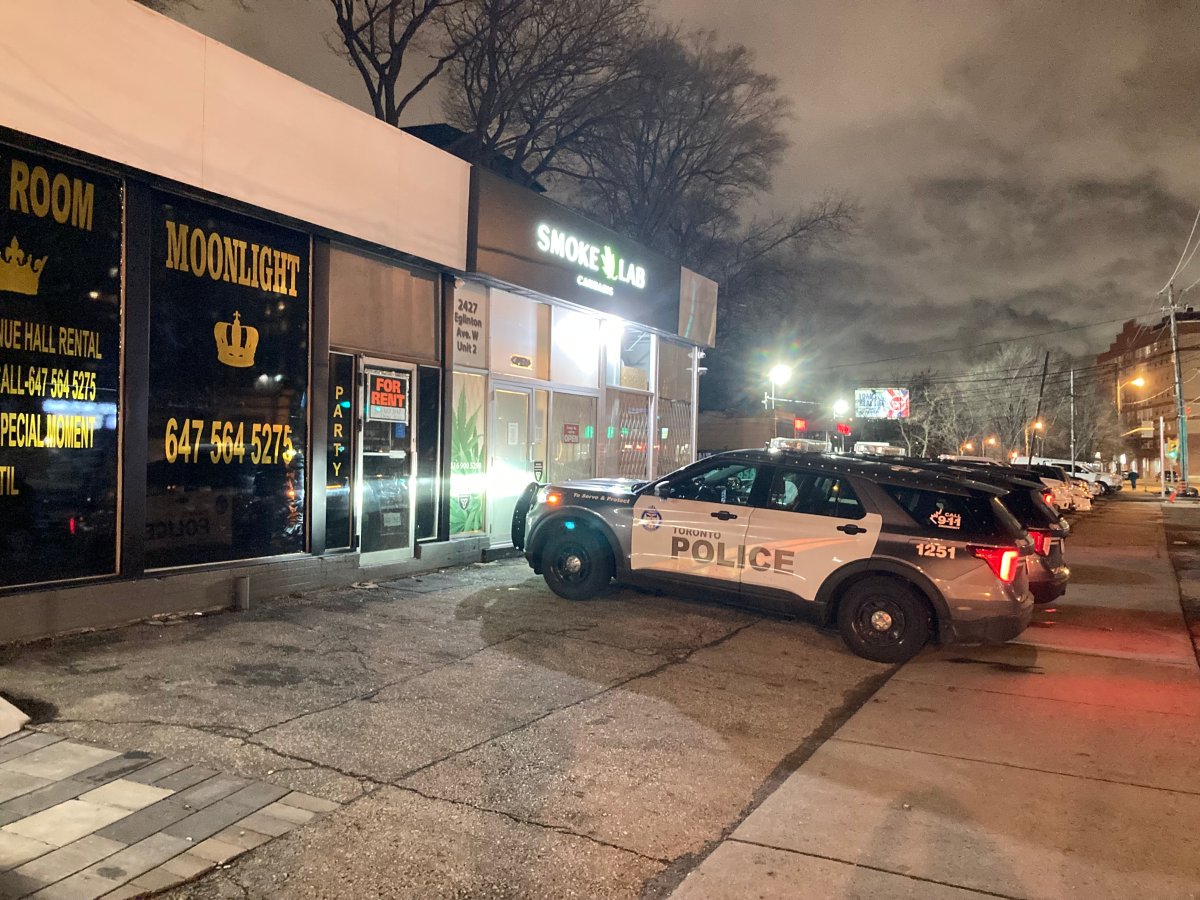 Police outside a a retail store at Eglinton Avenue West and Venn Crescent.