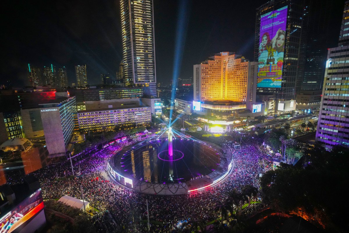 People gather in the main business district on New Year’s Eve in Jakarta, Indonesia, Tuesday, Dec. 31, 2024. (AP Photo/Tatan Syuflana)