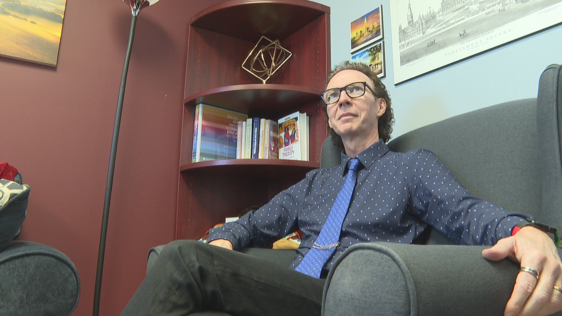 Kevin Cameron sits in a chair in his office.