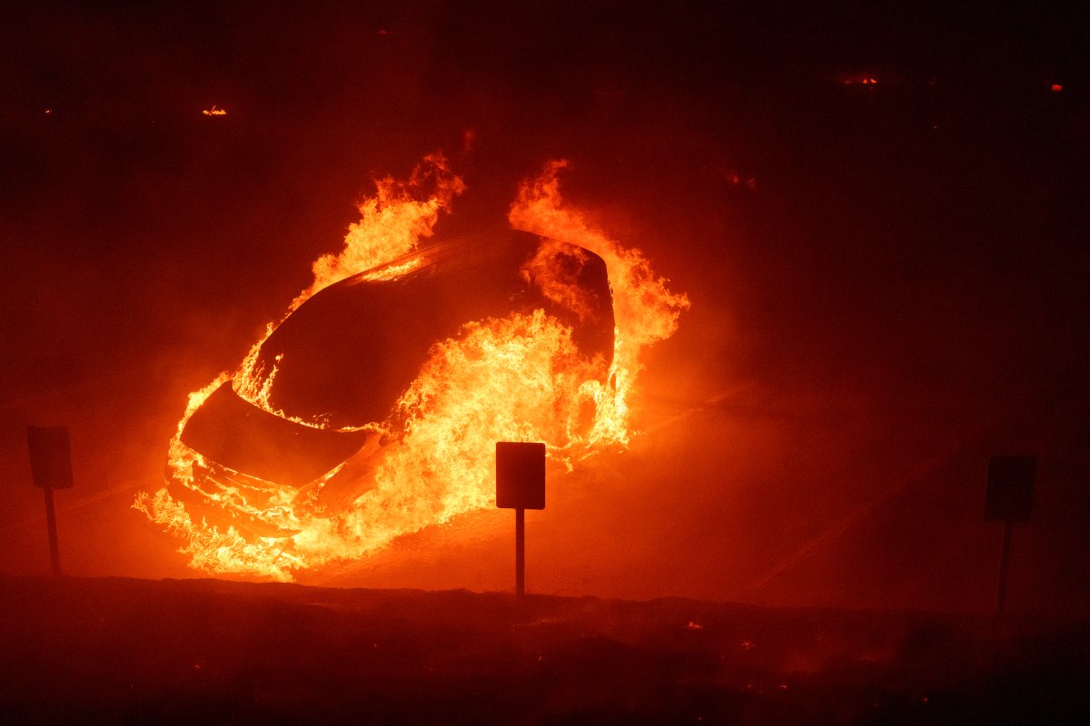 A vehicle burns during the Franklin Fire on the campus of Pepperdine University in Malibu, Calif., Tuesday, Dec. 10, 2024.