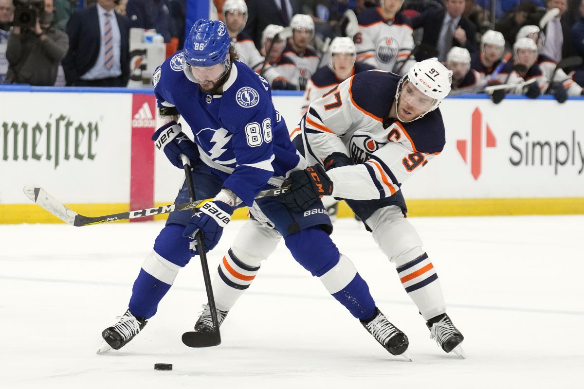 Edmonton Oilers centre Connor McDavid (97) gets his stick around Tampa Bay Lightning right wing Nikita Kucherov (86) during the second period of an NHL hockey game Wednesday, Feb. 23, 2022, in Tampa, Fla.