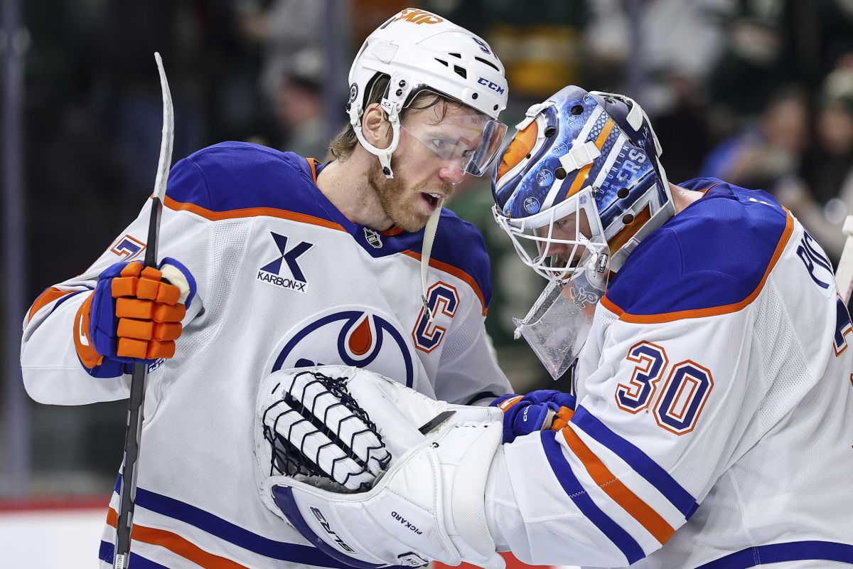 Edmonton Oilers centre Connor McDavid, left, and goaltender Calvin Pickard celebrate their teams win against the Minnesota Wild after an NHL hockey game Thursday, Dec. 12, 2024, in St. Paul, Minn.