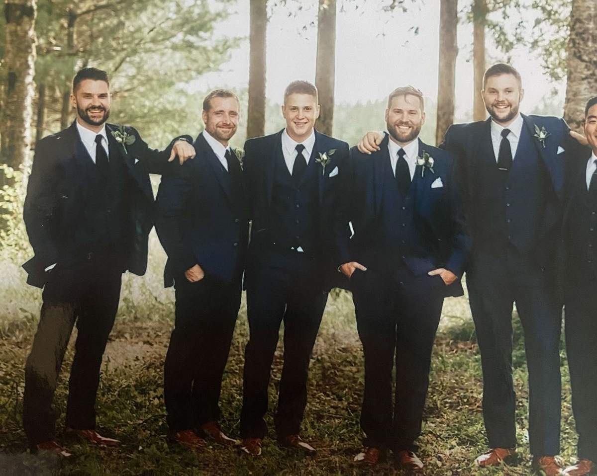 Nathaniel Burchat, middle, at his brother’s wedding.
