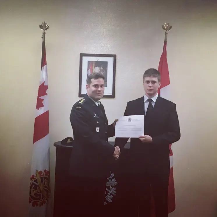 Nathaniel Burchat, right, being sworn into the Canadian Armed Forces by his brother.