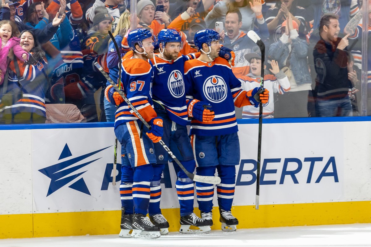 Edmonton Oilers' Leon Draisaitl (29) celebrates his game winning goal against the San Jose Sharks with his teammates Connor McDavid (97) and Evan Bouchard (2) during overtime NHL action in Edmonton, Saturday, Dec. 21, 2024.