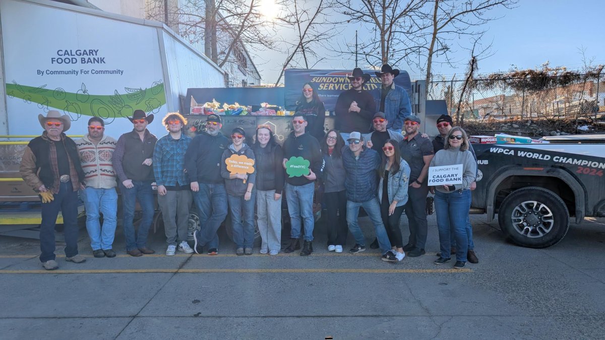 Chanse Vigen and other stand in front of his chuckwagon outside the Calgary Food Bank