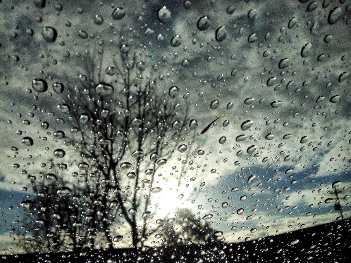 File photo of raindrops appearing on a windshield.