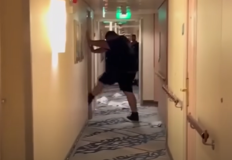 In a screengrab from video supplied to Fox 11, Michael Virgil appears to try to kick down a door where a Royal Caribbean staff member was allegedly hiding.