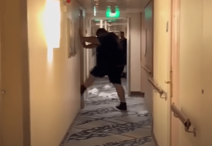 In a screengrab from video supplied to Fox 11, Michael Virgil appears to try to kick down a door where a Royal Caribbean staff member was allegedly hiding.