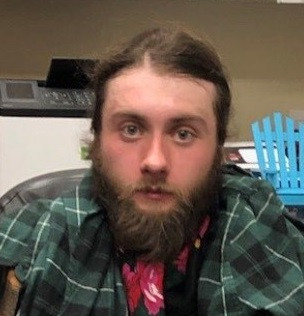 Calgary Police accuse 21-year-old Finbar Hughes of setting a house in the city's Hillhurst neighbourhood on fire in an attempt to extort a Bitcoin payment from the residents.