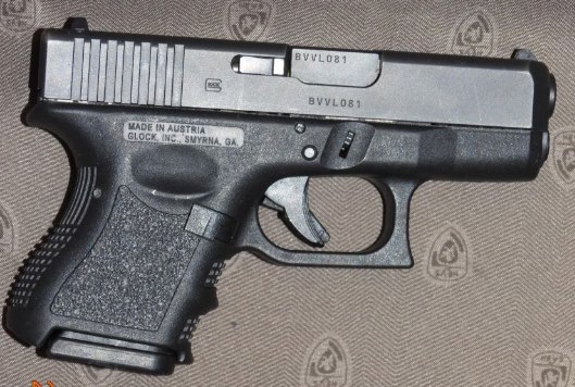 A loaded Glock handgun was among a cache of firearms and illegal magazines seized by Calgary Police when they raided several residences in October 2024.