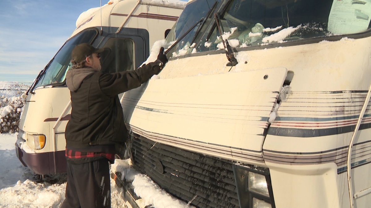 Victor LaRock, seen clearing snow from his RV before being forced by the city of Calgary to move it, says he's lived along Moraine Road northeast for more than a decade.