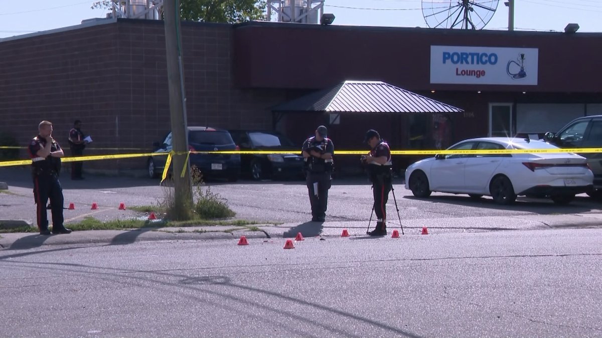 Calgary Police examine evidence markers following a violent altercation outside the Portico Lounge in northeast Calgary in September 2024.