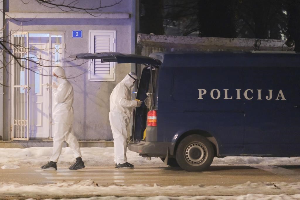 Police investigators work at the site of a shooting in Cetinje, 36 kilometers (22 miles) west of Podogrica, Montenegro, Wednesday, Jan 1, 2025. (AP Photo/Risto Bozovic).